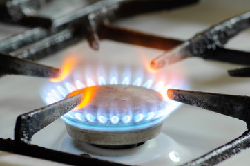 Gas burner on a white kitchen stove