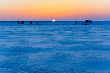 Sunrise in winter in the field