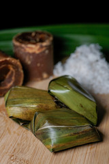 Koci the malay glutinous rice ball served in banana leaf . Malaysian Dessert / Kuih