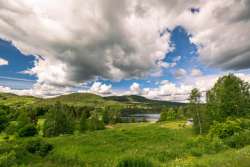Fototapeta na wymiar Nordic countryside, beautiful green valley, travel concept, summer landscape, green fields and blue sky, Sweden.