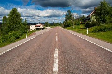 Nordic countryside, beautiful asphalt road in green valley, travel concept, summer landscape, green fields, empty street Sweden.
