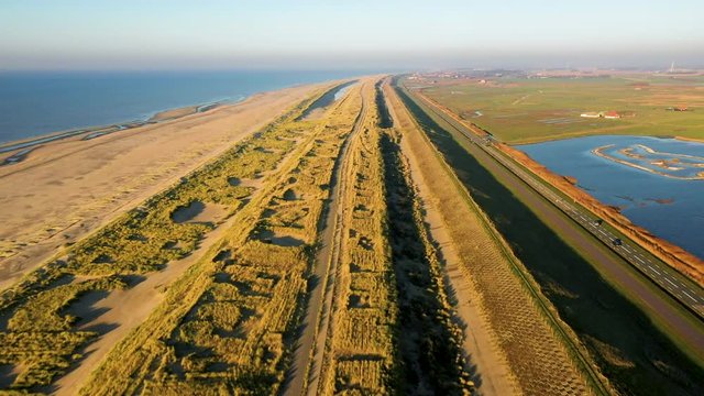 People walking on the beatch - Dutch coastline Hondsbossche seawall