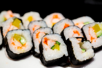 Sushi set on white plate with selective focus