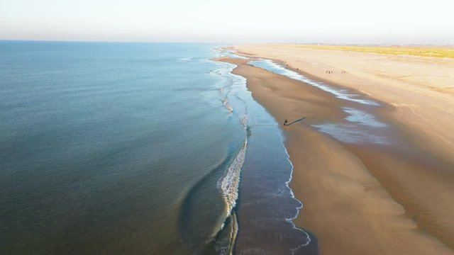 People walking on the beatch - Dutch coastline Hondsbossche seawall
