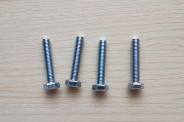 metal bolts on wooden background