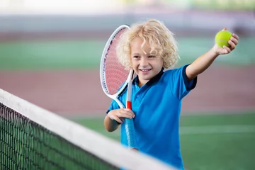 Foto op Canvas Child playing tennis on outdoor court © famveldman