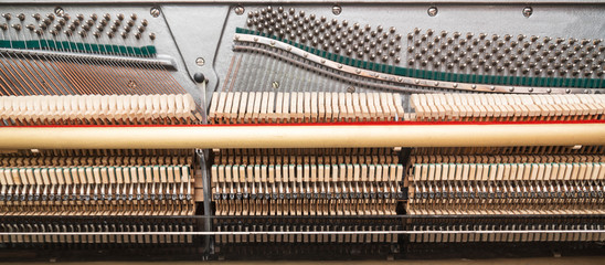 Close-up view of hammers and strings inside the piano.