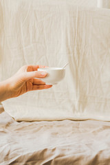 cream sauce.with chili pepper in a ceramic bowl in the hands of a young woman