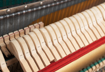 Close-up view of hammers and strings inside the piano.