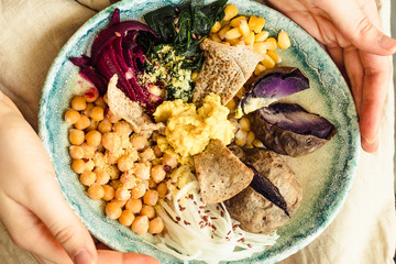 Colorful buddha bowl.Vegetarian. Middle eastern style.Close-up. A plate of food in the hands.