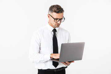 Handsome business man isolated over white wall background using laptop computer.