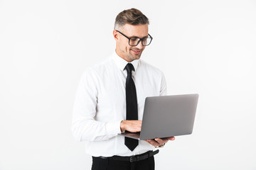 Handsome business man isolated over white wall background using laptop computer.