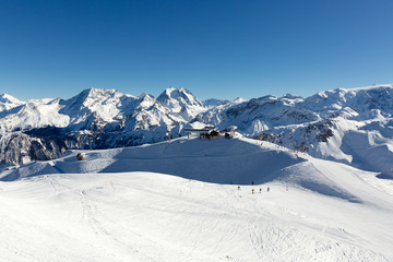 Slope on the skiing resort in Alps, France. Sunny winter day. Winter vacation