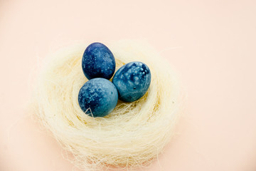 Yellow Easter eggs in a nest of grass. Eggs in a  nest basket top view.  Easter composition.Top view several objects horizontal view red background. Still life eggs White background. 