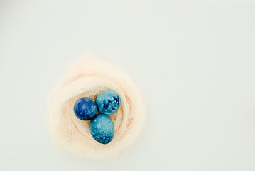 Yellow Easter eggs in a nest of grass. Eggs in a  nest basket top view.  Easter composition.Top view several objects horizontal view red background. Still life eggs White background.