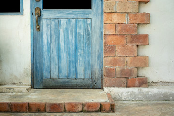 Antique blue wood doors and window with red brick wall