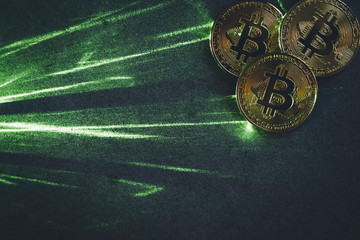 green laser beam and bitcoins in the dark