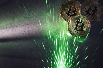 bitcoins and green laser beam light.