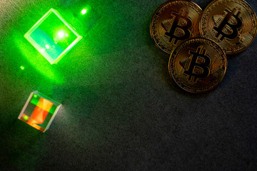 bitcoins and prisms with green laser glow