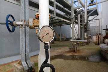 Pressure gauge at gas plant - measuring gas pressure - pipe and valve