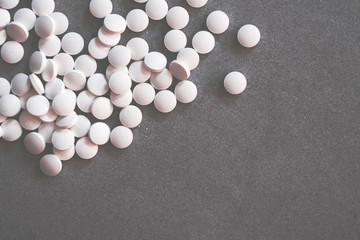 White pills on concrete table. Medical concept.