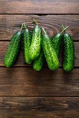 Fresh green cucumbers on wooden background. Top view