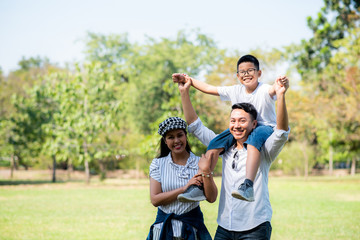 Happy children and parents playing in the park. Concept family relaxation.