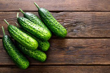 Fresh green cucumbers on wooden background. Top view