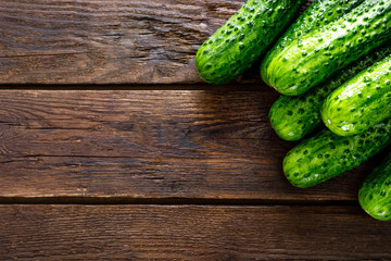 Fresh green cucumbers on wooden background. Top view