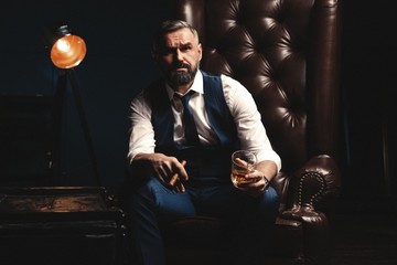 Attractive man with cigar and a glass whiskey