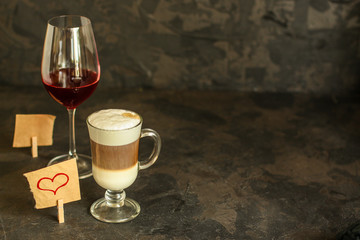 red wine, transparent glass (beverage and a note with a heart). top copy space