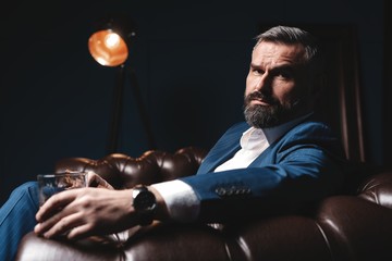 Attractive man with cigar and a glass whiskey