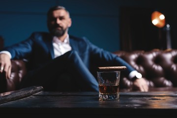 Attractive man with cigar and a glass whiskey