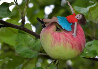 abstract little girl sitting on an Apple collage of photos