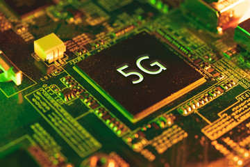 5g chip on motherboard with mixed artificial light. Communication, future and tech concept.