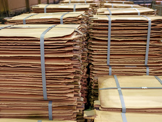 Stacks of copper sheets. Warehouse of finished products at the metallurgical plant. Closeup.