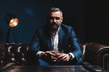 Attractive man with cigar and a glass whiskey