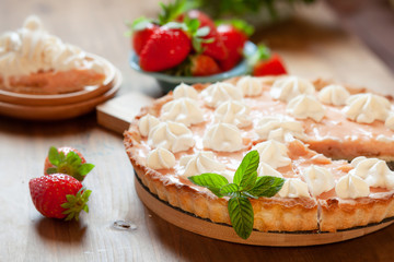 Strawberry tart cake decorated with whipped cream and fresh berries. Summer dessert pie
