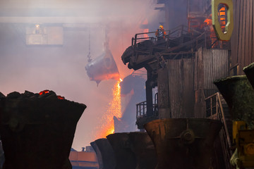 Copper production at the metallurgical plant. Large industrial structures and overhead cranes....