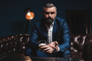 Attractive man with cigar and a glass whiskey