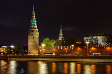 Fototapeta na wymiar Towers of Moscow Kremlin on a background of Kremlevskaya embankment of Moskva river. Night landscape of Moscow historical center