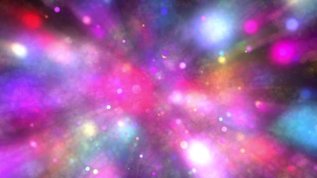 Rays of light emanate from colorful particles that form bokeh balls as they dance in and out of focus