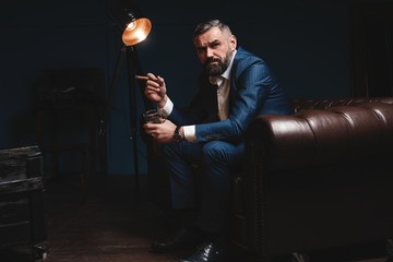 Attractive man with cigar and a glass whiskey