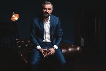 Attractive man with cigar and a glass whiskey