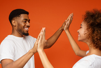 Happy black man and woman clapping their hands