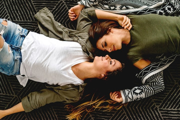 Female lovers lying on the floor