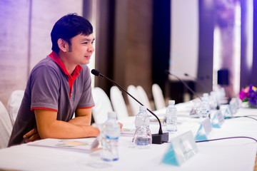 Business man is making a speech in front of a big audience