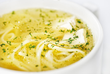 Bowl with chicken soup on white background
