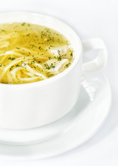 Bowl with chicken soup on white