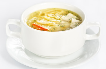 Bowl with chicken soup on white